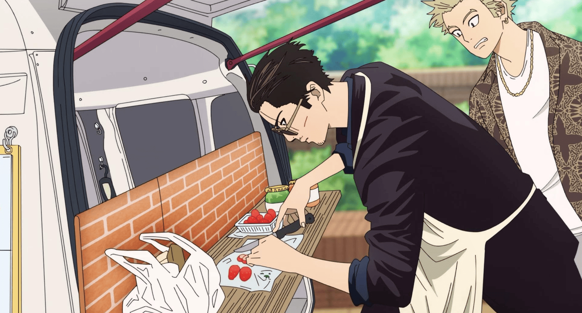 A man makes dessert in a food truck in this image from J.C. Staff.
