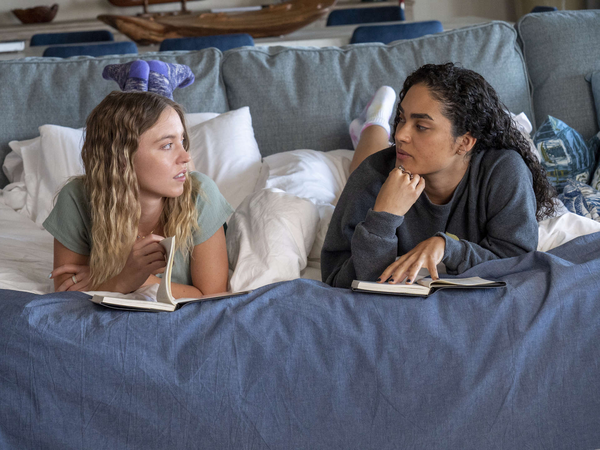 Two young women are in bed together in this photo from Rip Cord Productions