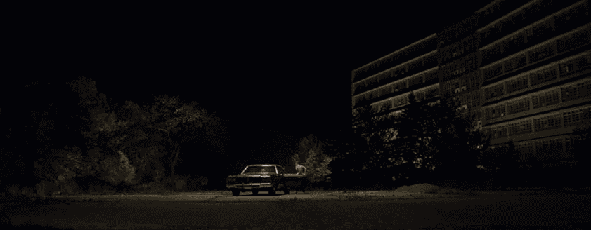 A person gets into a car at night in this image from Northern Lights Films.