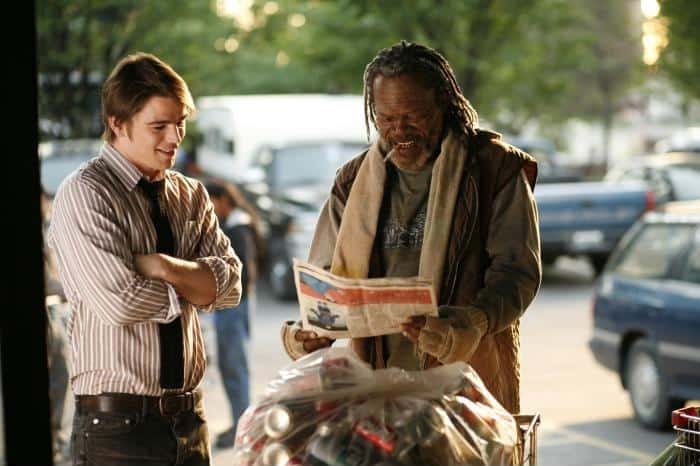 Two men look at a newspaper in this image from Phoenix Pictures.