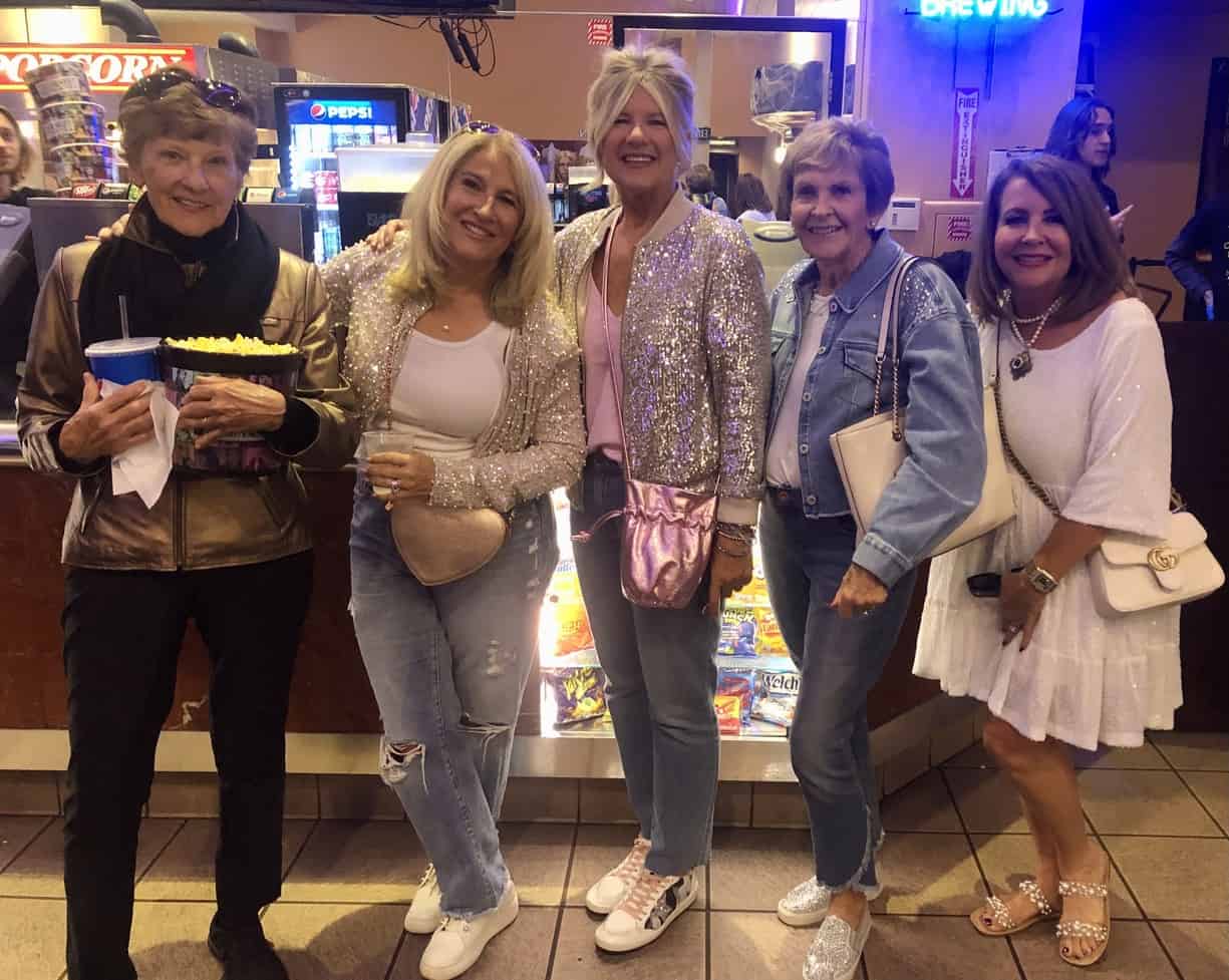 Five energetic women sparkle at the movie theater in this image taken by the author.