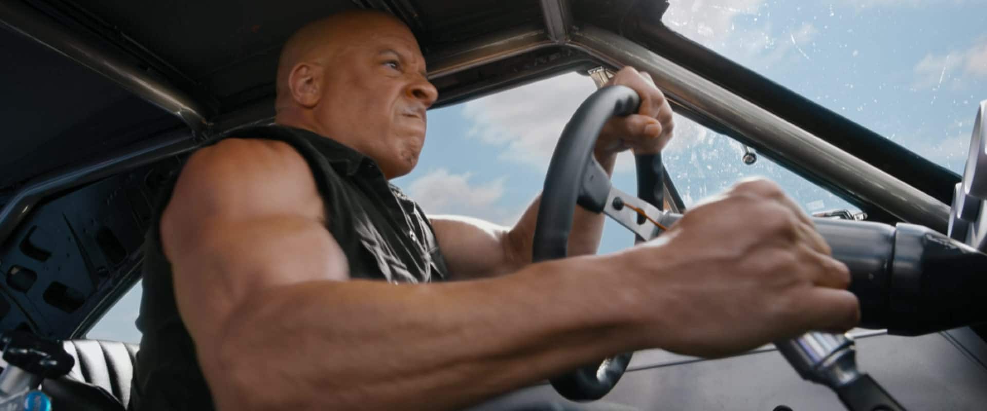 A man braces himself while driving fast in this photo from One Race Films.