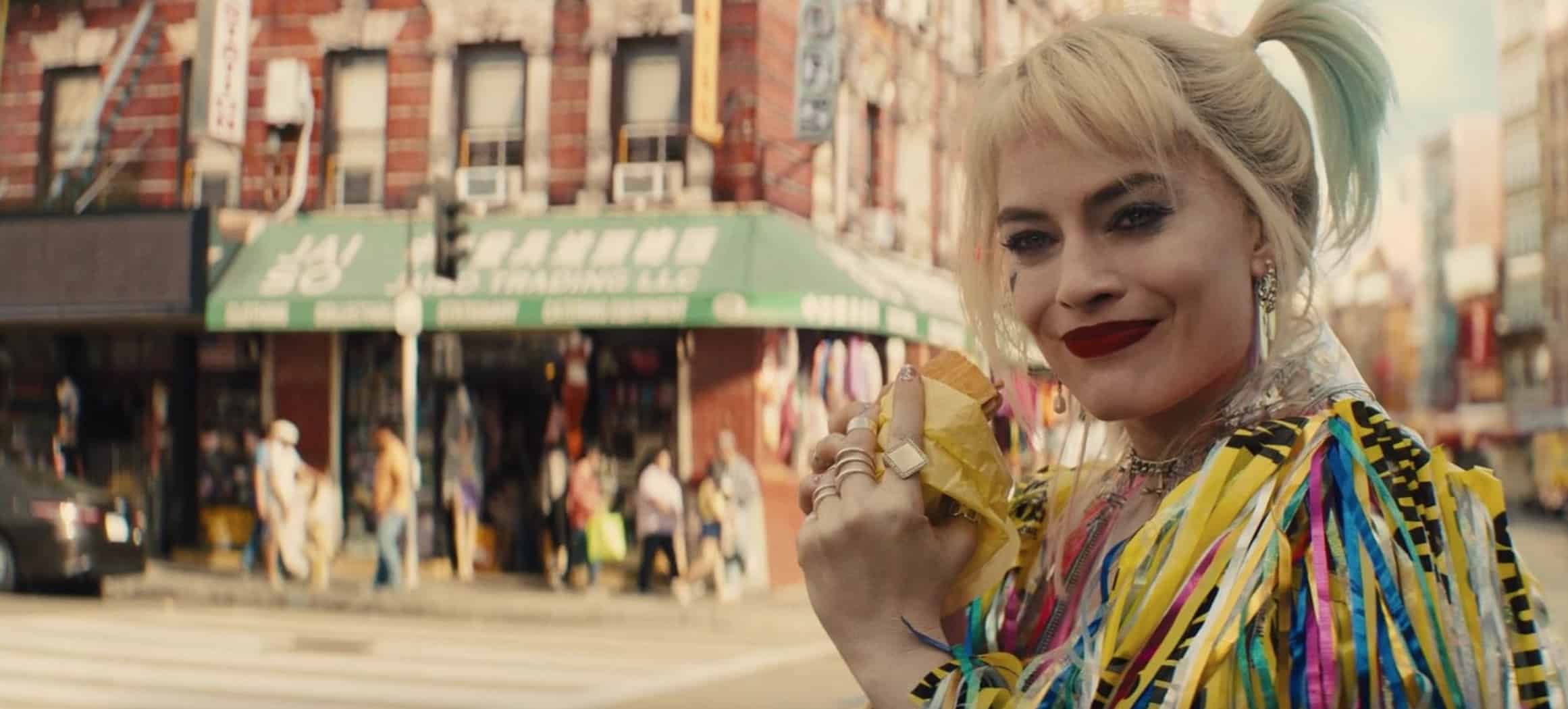 A woman in bright clothing holds a breakfast sandwich in this image from Warner Bros.