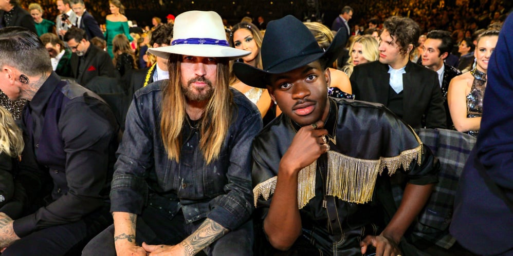 Billy Ray Cyrus and Lil Nas X seated in an auditorium in this photo from Shutterstock.