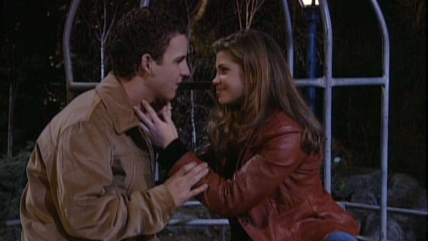 A teenage couple sits together on the monkey bars in a park in this image from Touchstone Pictures.