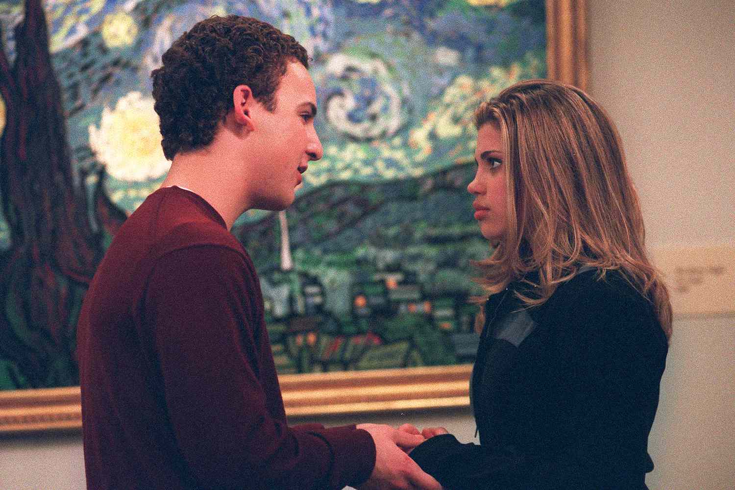 A teenage couple stands in front of the Vincent van Gogh painting “Starry Night” in this image from Touchstone Television.