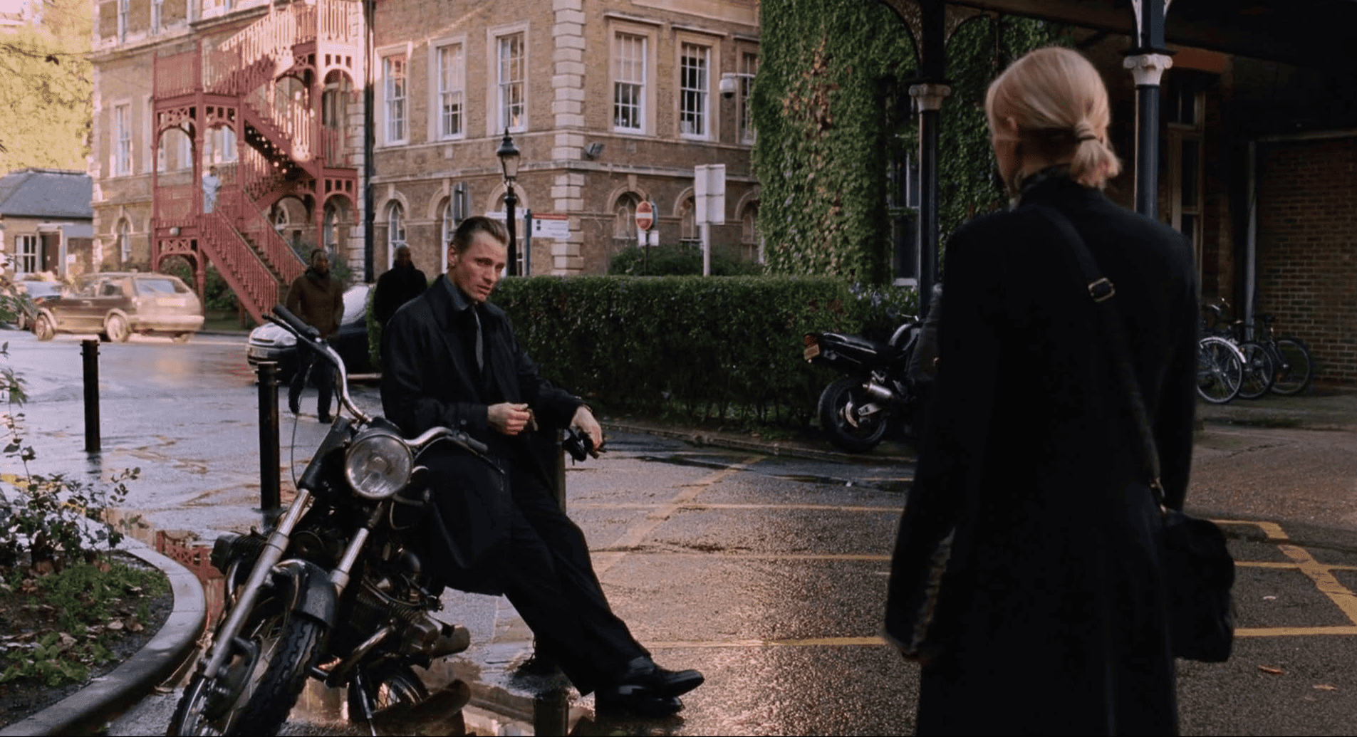 A woman approaches a man sitting on a motorcycle in this image from Focus Features.