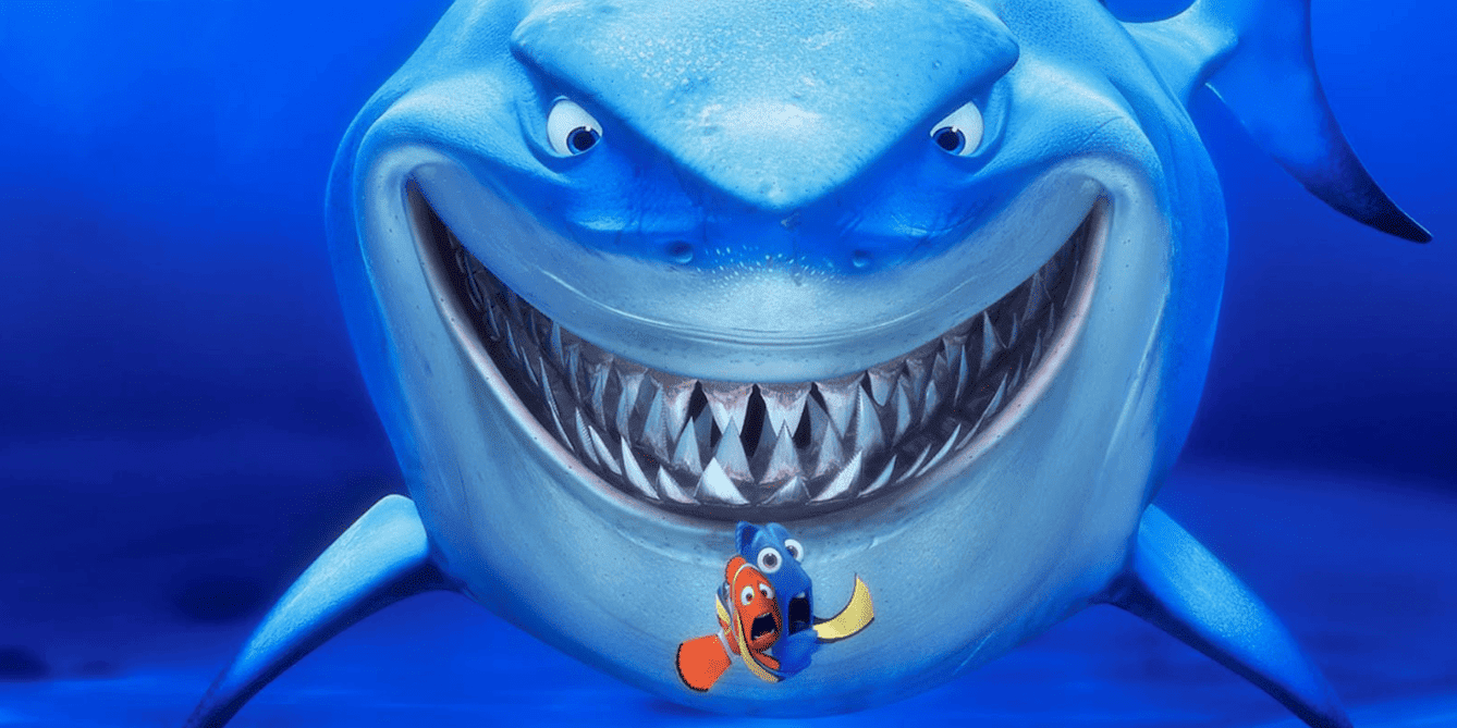 Two fish cling together in fear as a shark looms over them in this image from Pixar Animation Studios.