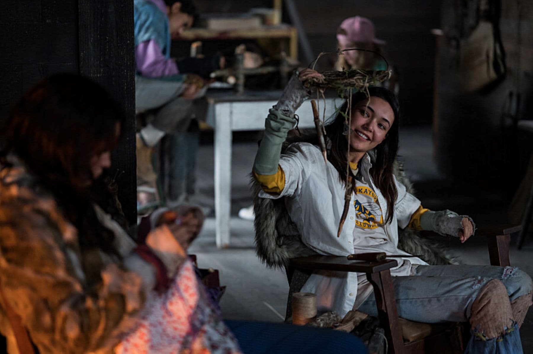 A girl holds a handcrafted mobile and smiles in this photo by Showtime.