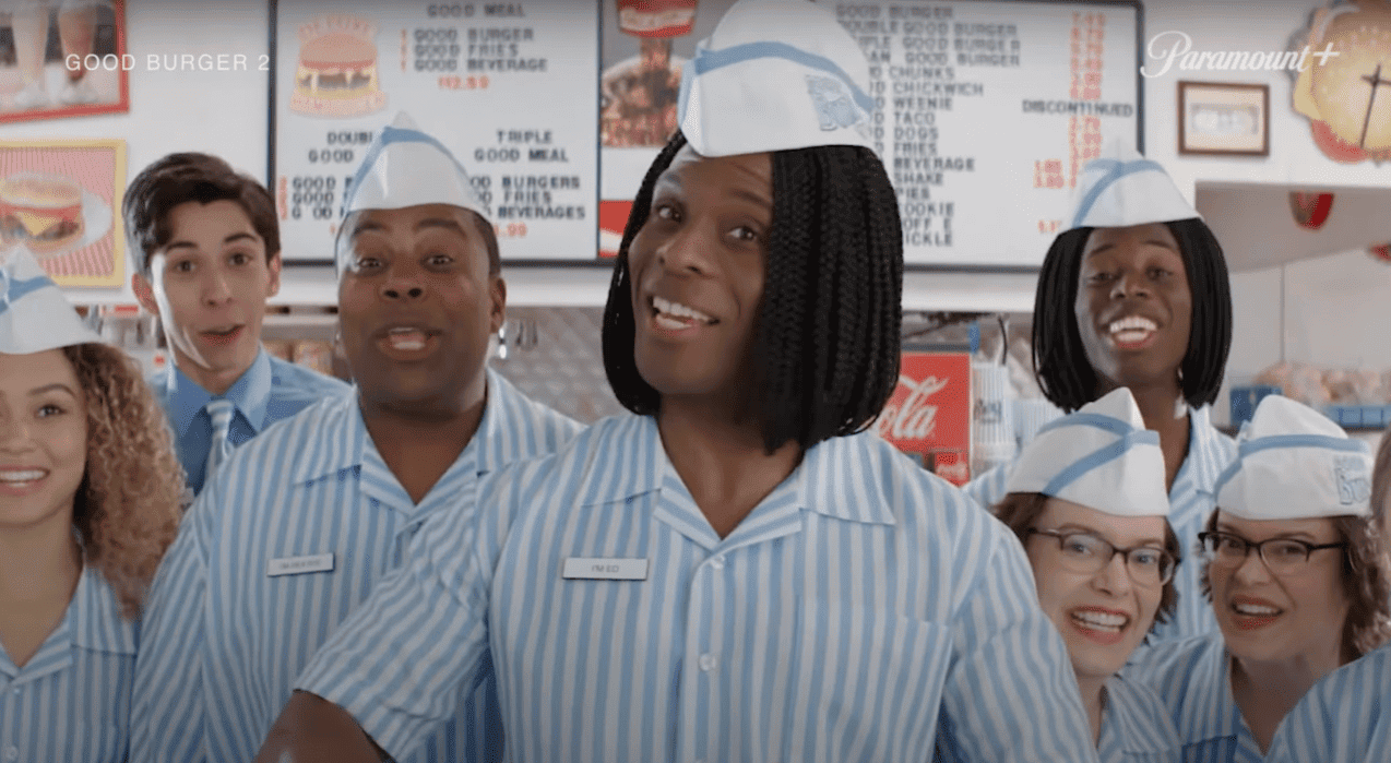 A group of fast food workers smile at someone off-screen in this image from Paramount Pictures.