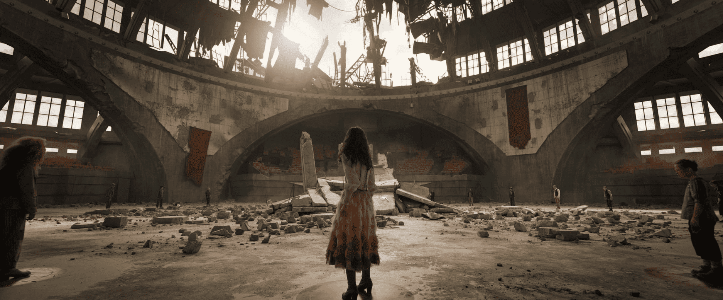A girl stands in a blown-apart arena in this image from Lionsgate Films.