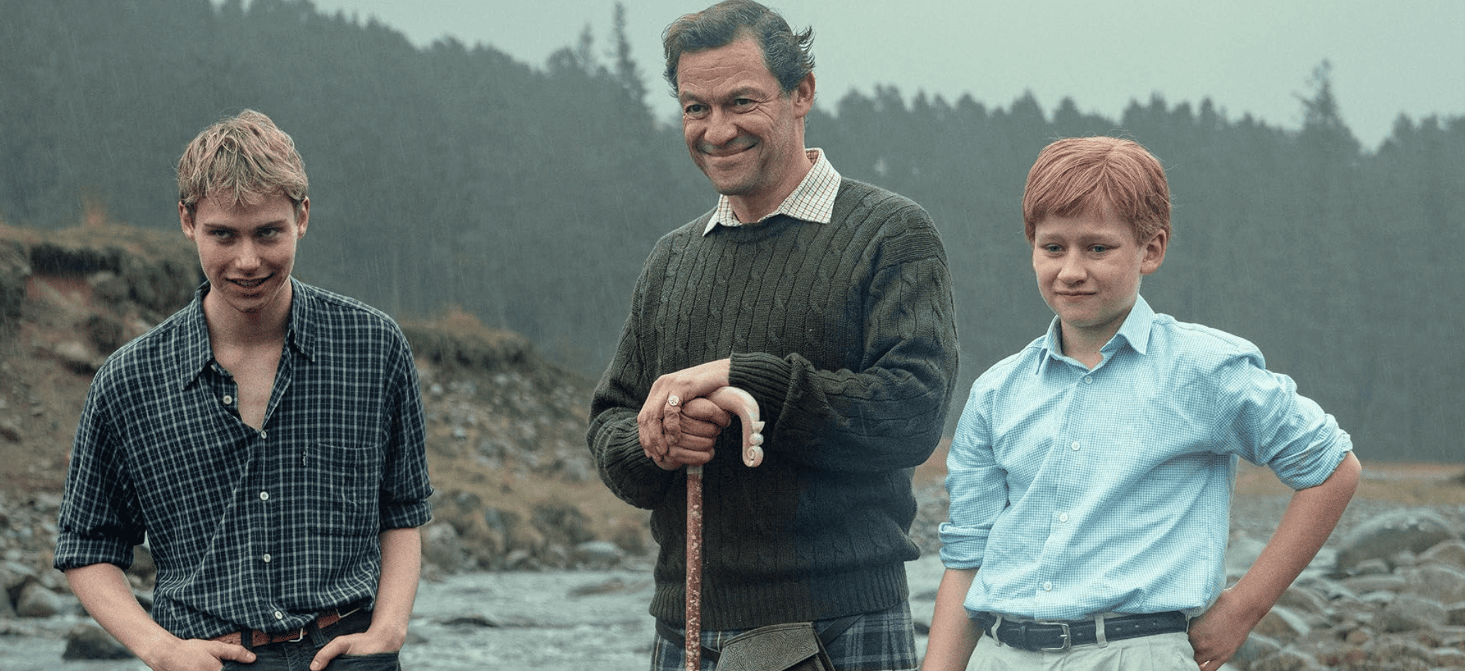 Two boys stand with an older man by a river in this image from Sony Pictures Television.