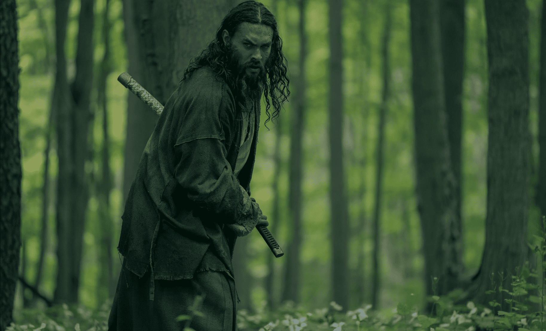 A man sheathes a katana in the woods in this image from Chernin Entertainment. 