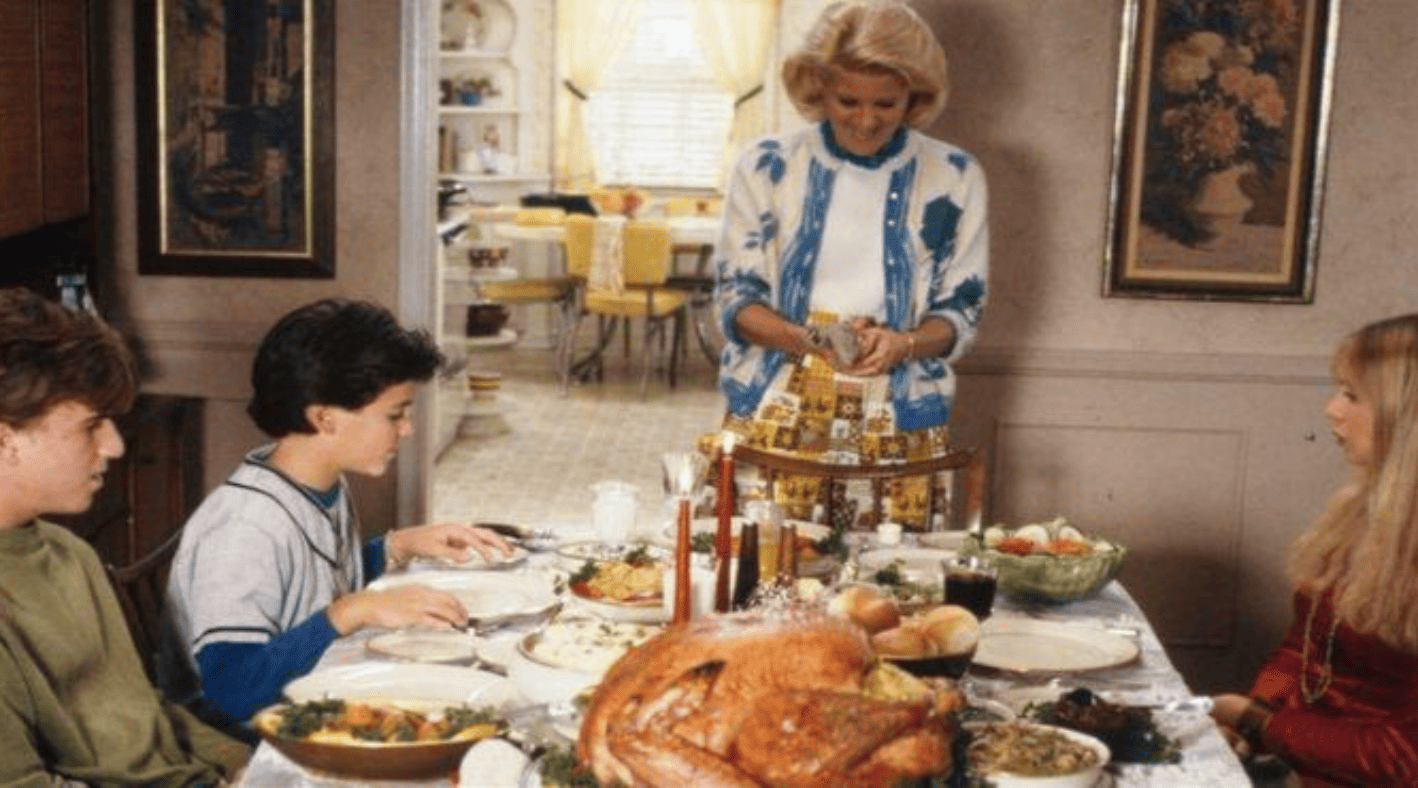 A family of four gathers around a Thanksgiving table in this photo by The Black-Marlens Company.