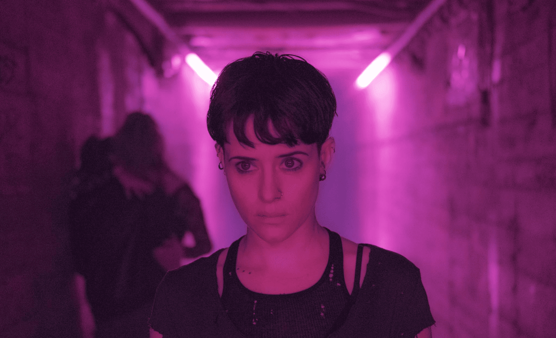  A woman walks down a pink-lit hallway in this image from Columbia Pictures.