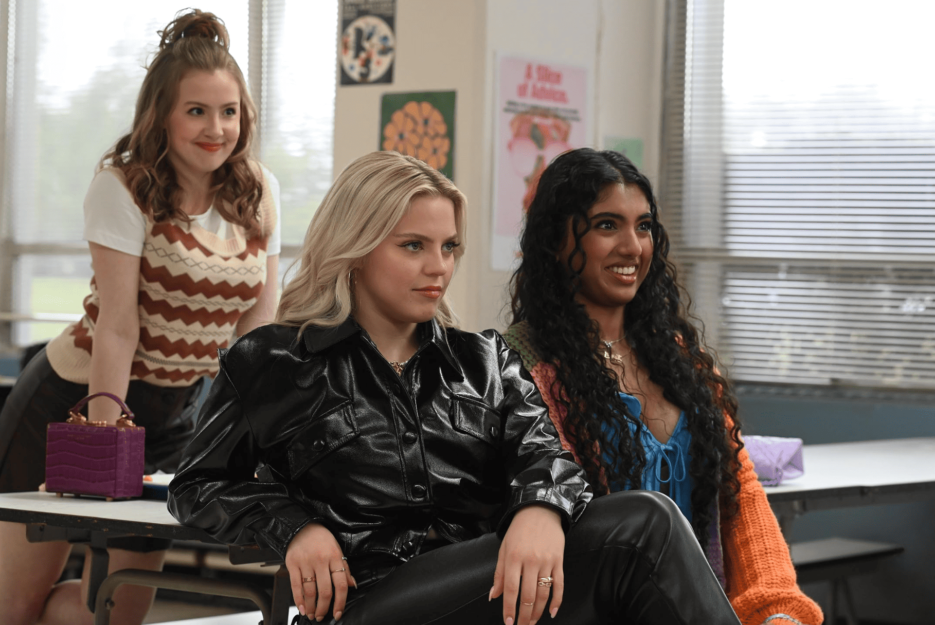 Three young women smile at someone in a classroom in this image from Paramount Pictures.