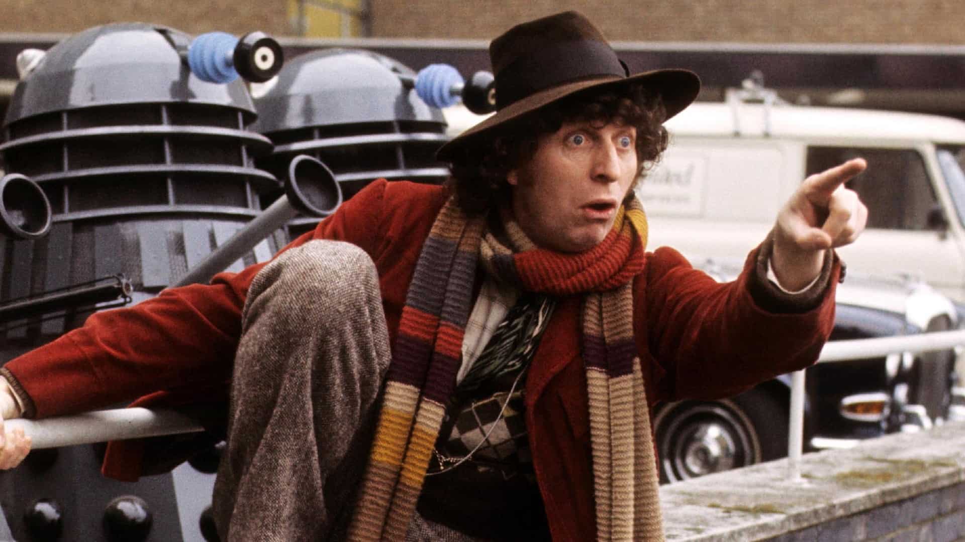A man in a parking lot with Daleks in this photo from British Broadcasting Corporation.