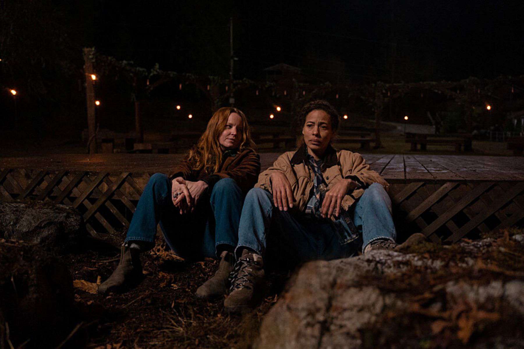 Two women sit side by side outside in this photo by Showtime.