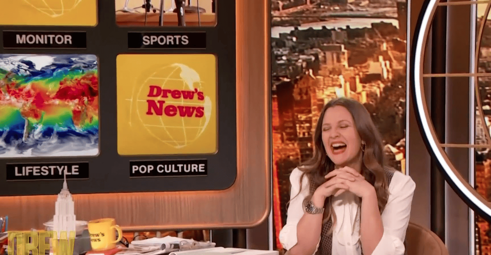 Drew Barrymore laughing while being on the set of her show in this image from Big Ticket Television.