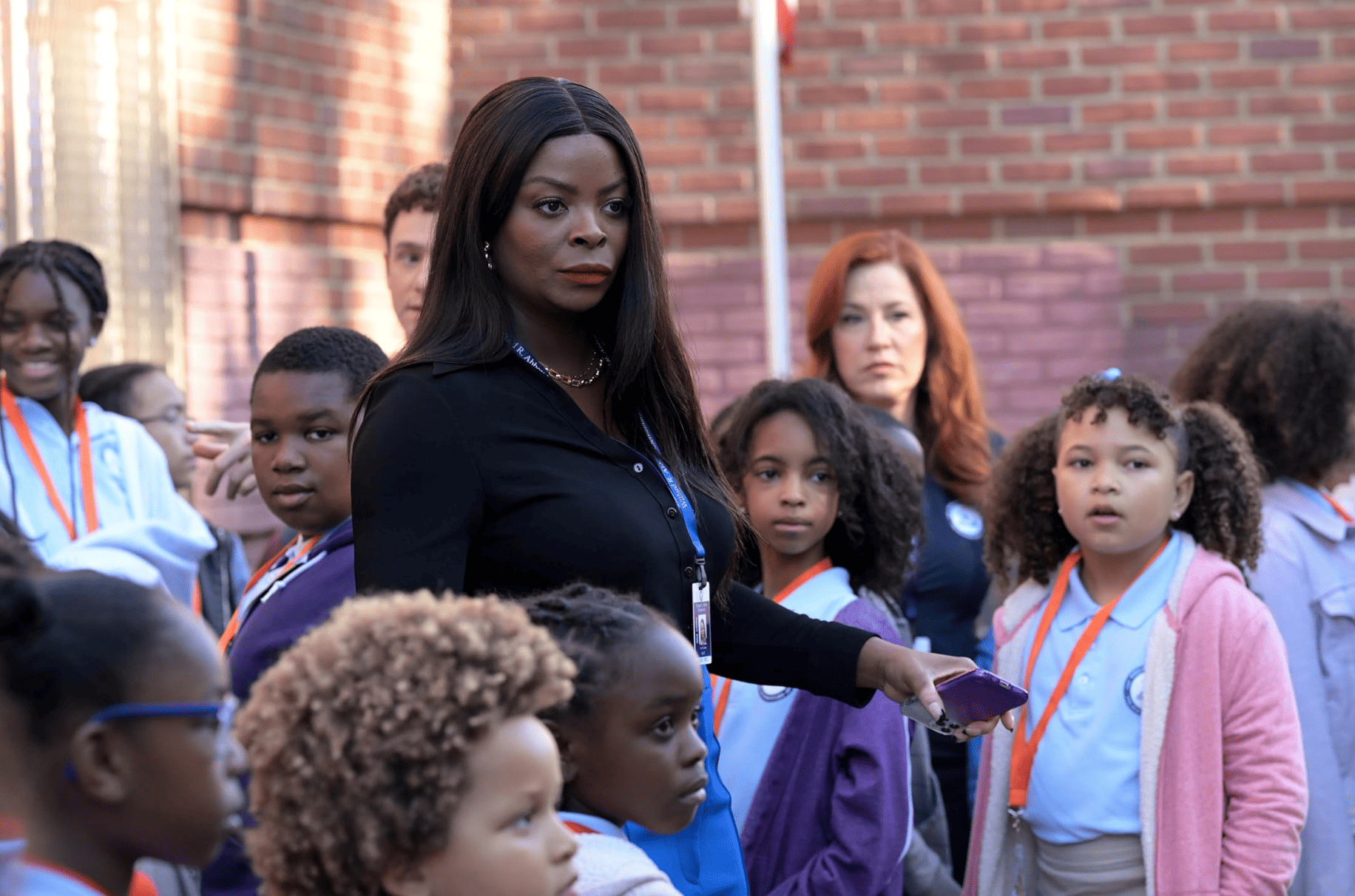 A woman stands in a crowd of students in this image from Warner Bros.