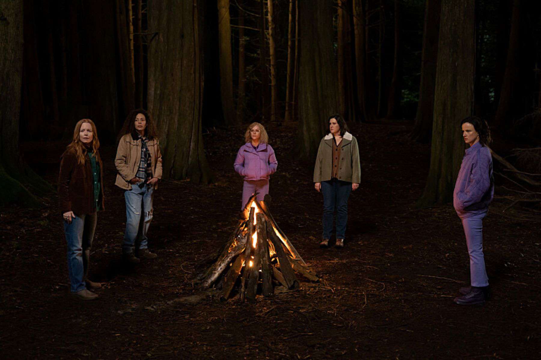 A group of women stand around a bonfire in this photo by Showtime.