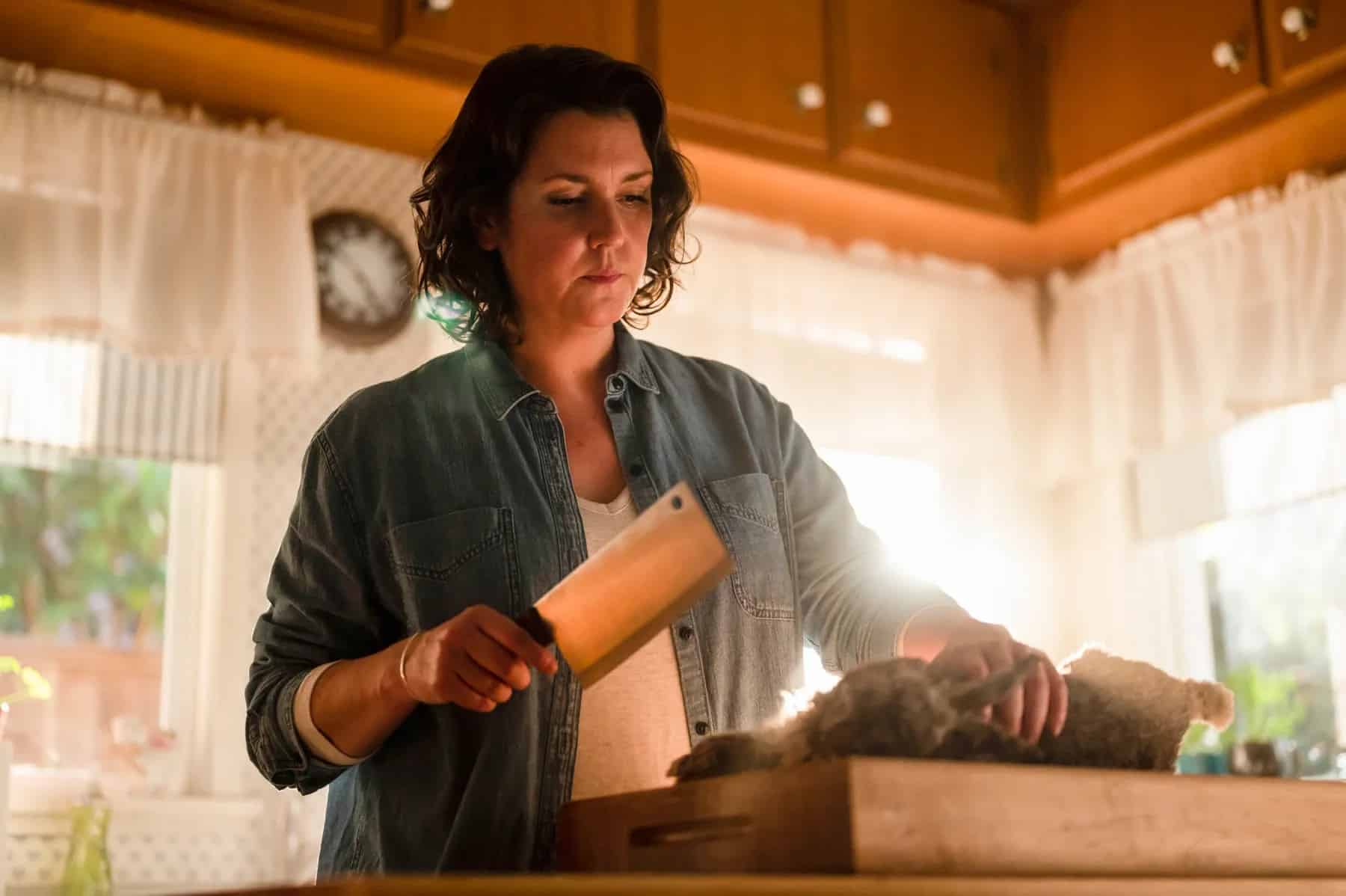 A woman prepares to butcher a rabbit in this photo by Showtime.