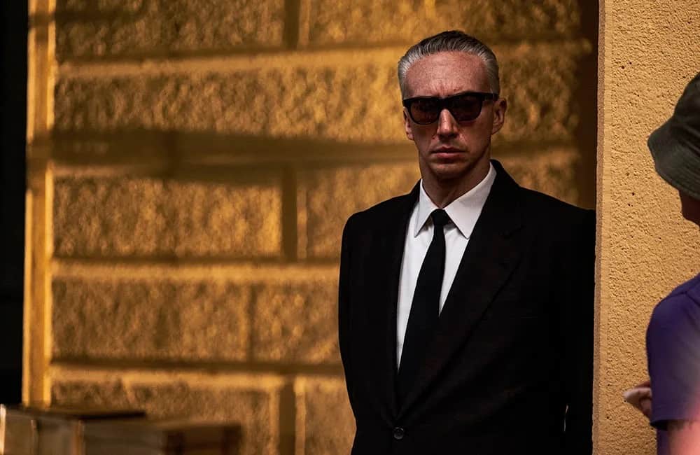 A man in a suit and sunglasses in this image from Forward Pass.