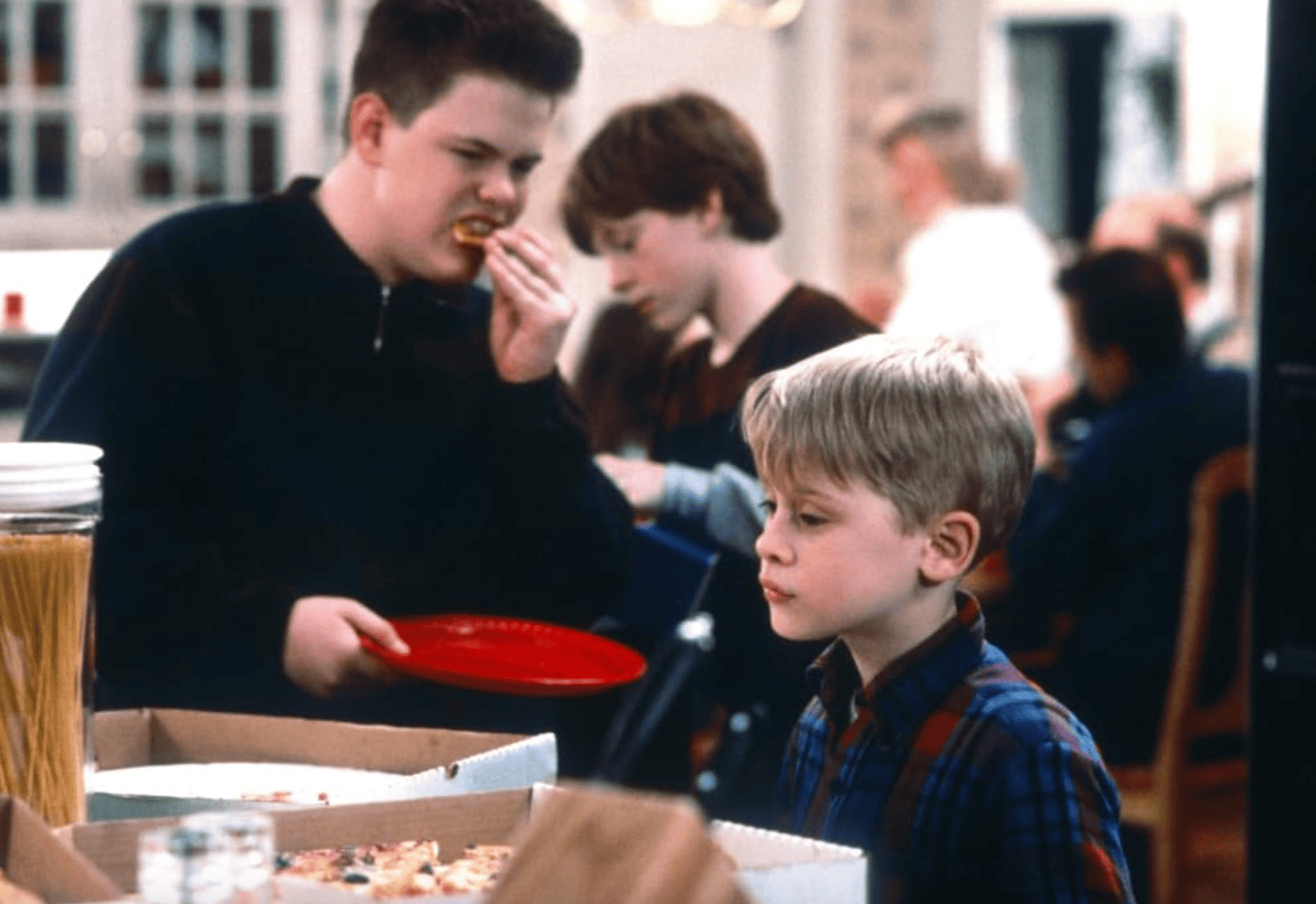 One kid fends for himself at a chaotic family dinner in this image from 20th Century Fox.
