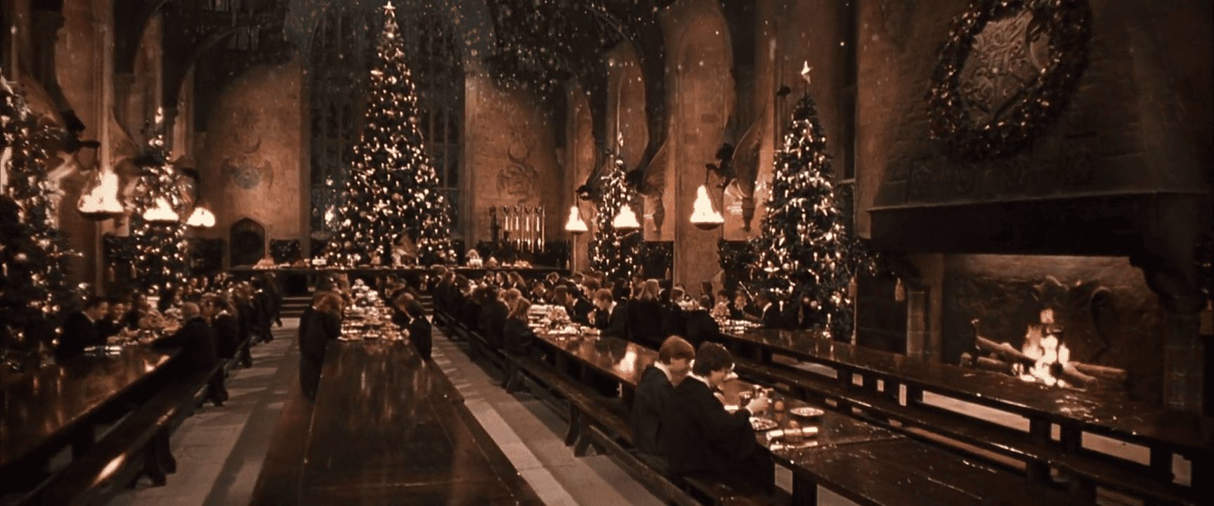 Students sit in a dining hall that’s decorated for Christmas in this image from Warner Bros. Pictures.