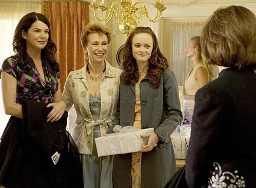 Three women enjoy a wedding reception together in this image from Warner Bros. Television. 