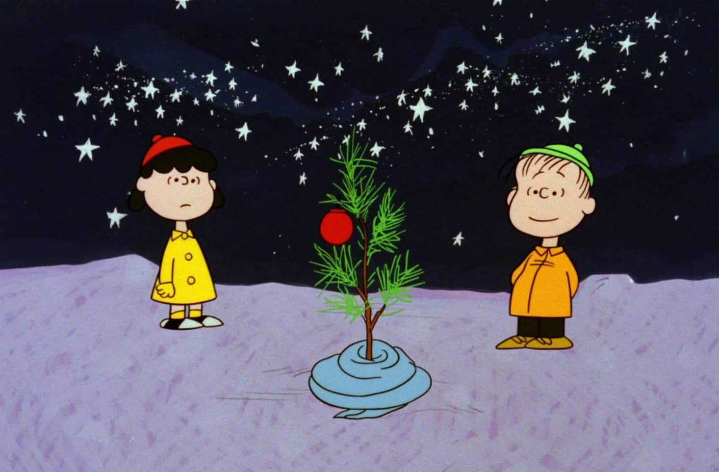 Animated characters Lucy and Linus looking at a small tree in this image from Lee Mendelson Film Productions.