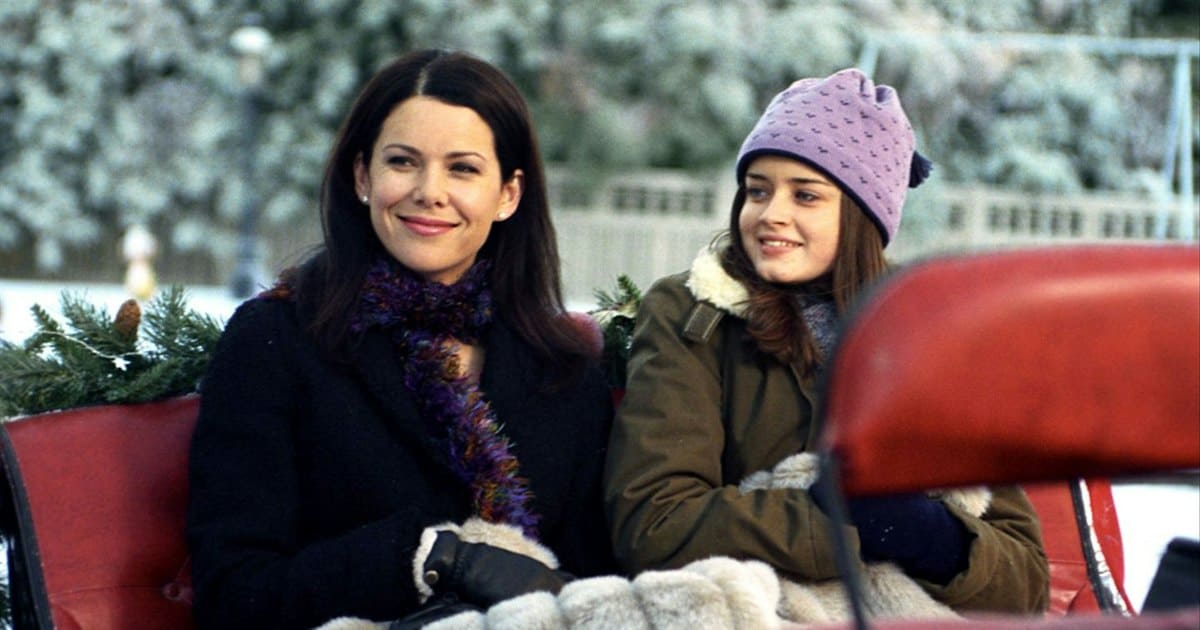  A mother and daughter ride in a sleigh through a snowy neighborhood in this image from Warner Bros. Television.
