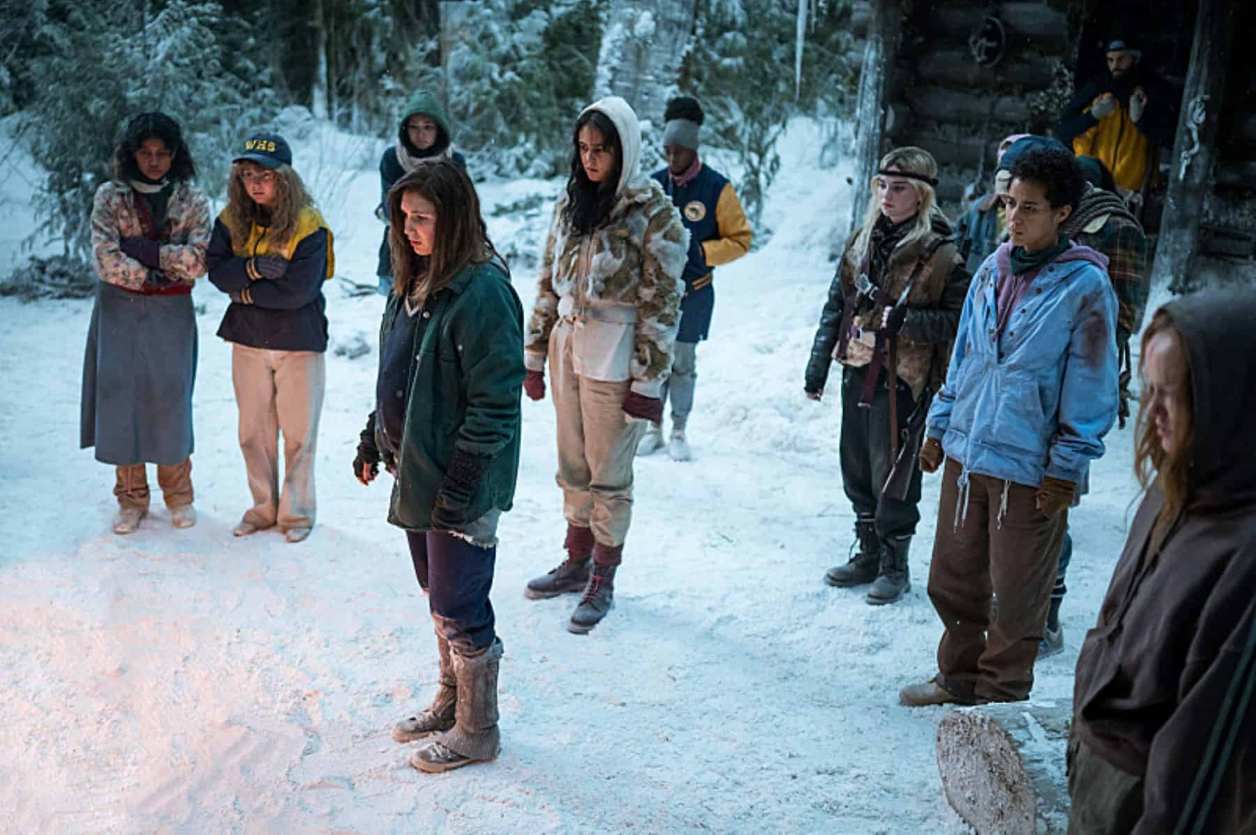 A group of teenagers standing outside in the snow look at something offscreen in this photo by Showtime.