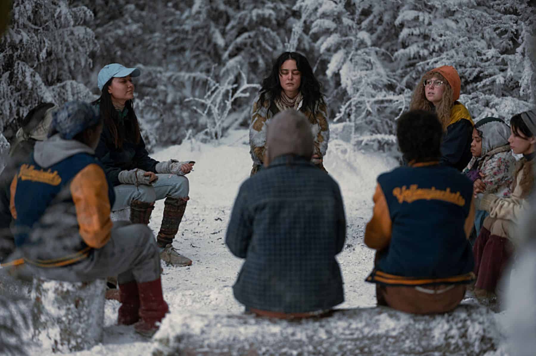 A group of teenage girls sit outside in a prayer circle in this photo by Showtime.