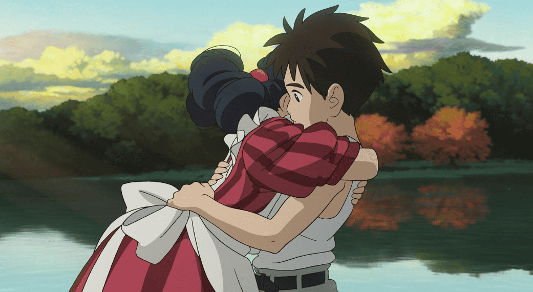 An animated young girl hugs a young boy in this image from Studio Ghibli.