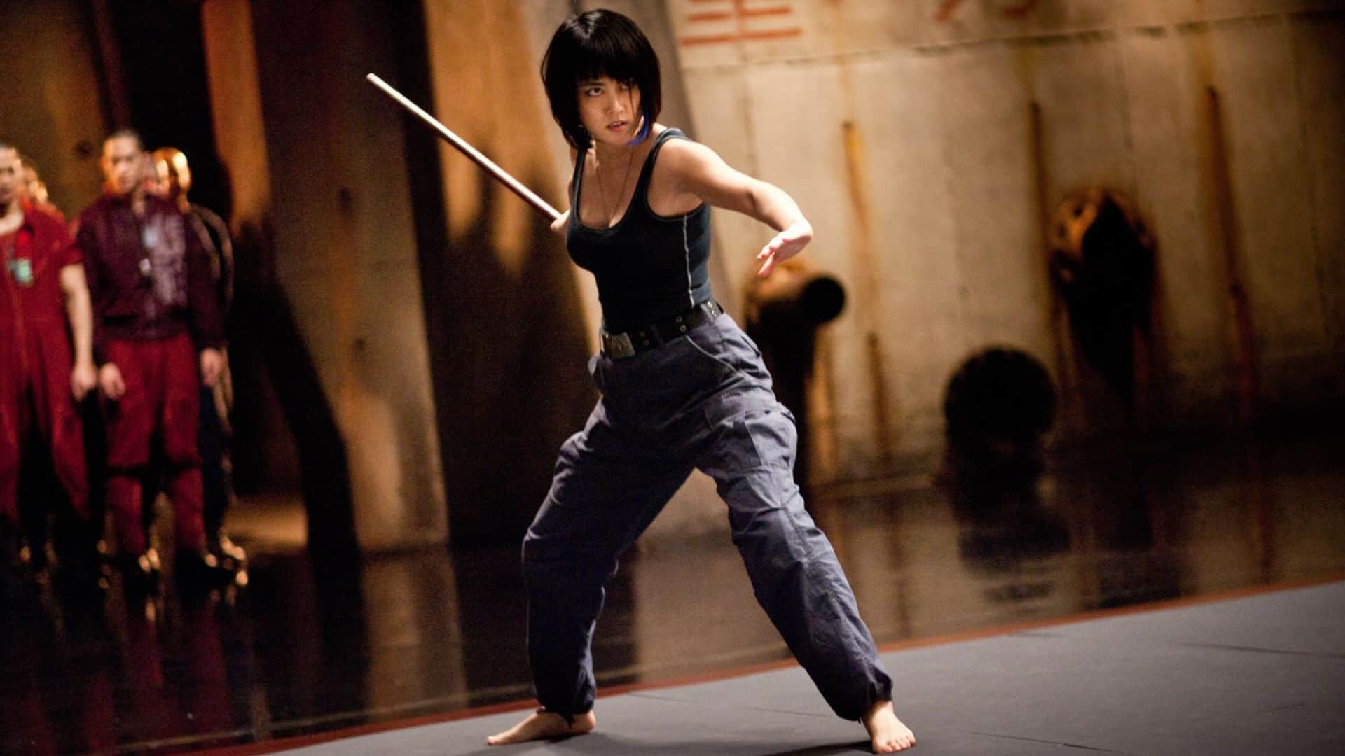 A woman on a sparring mat training with a wooden sword in this image from Legendary Entertainment.
