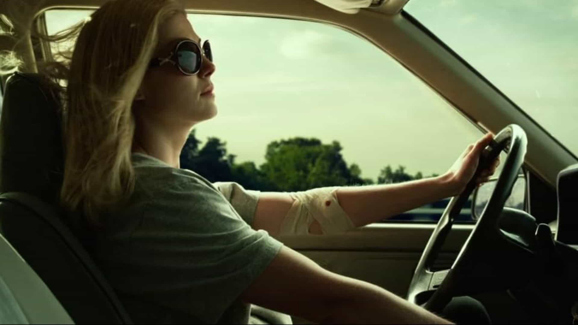 A woman with a bandage on her arm driving with the window down in this image from Twentieth Century Fox