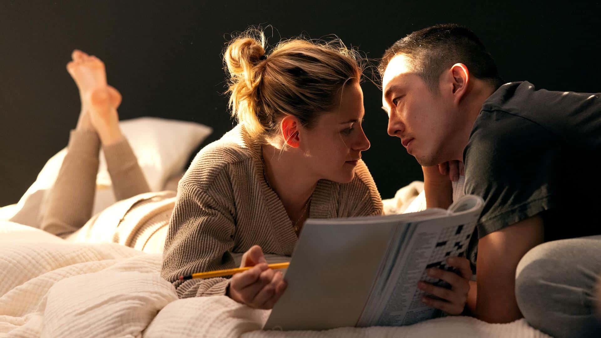  A woman and man about to kiss while doing a crossword in this photo from AgX.