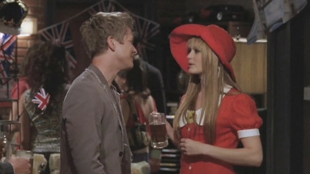  A boy and girl talk at a British-themed party in this image from Warner Bros. Television.