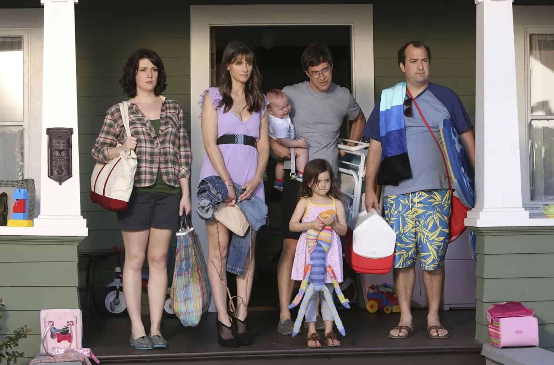 A family stands on a porch in this photo by HBO Entertainment.