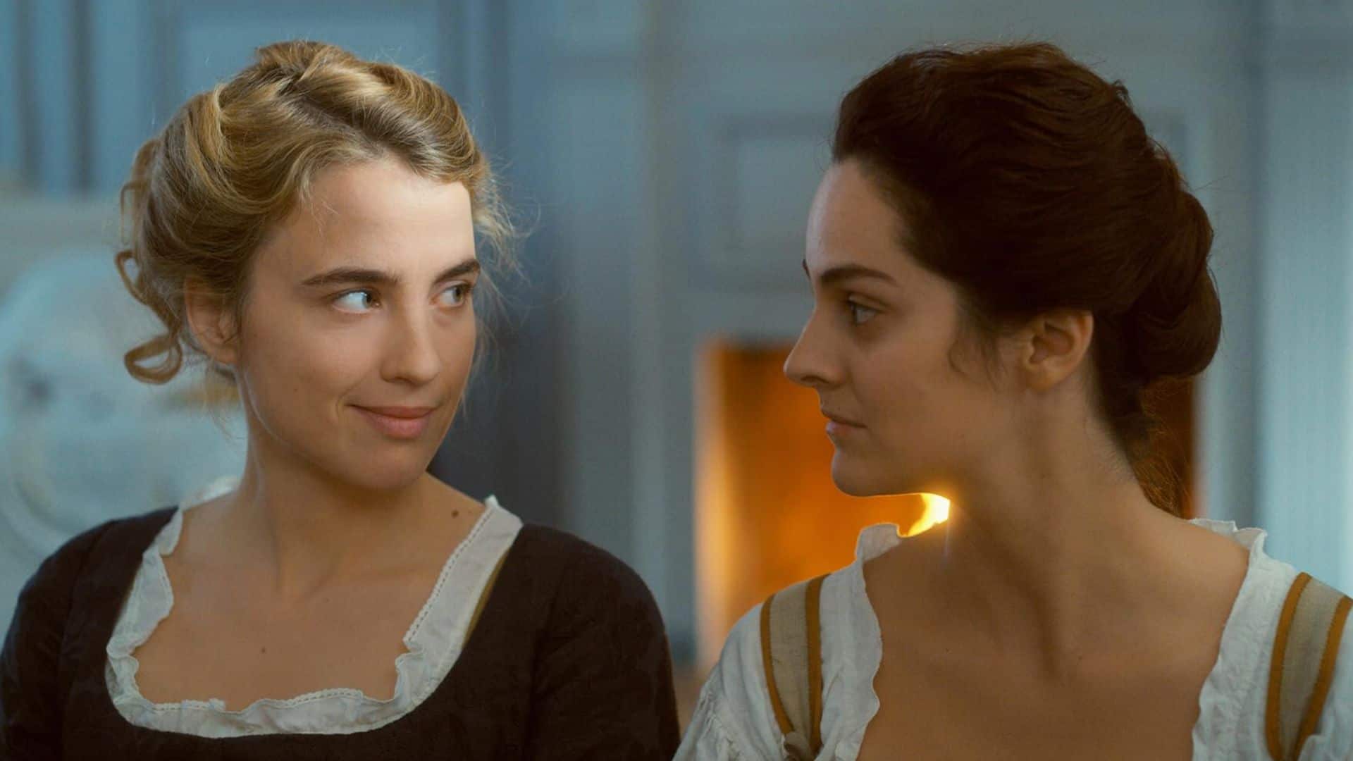 A blonde woman looks and smiles at a brunette woman in this image from Lilies Films.