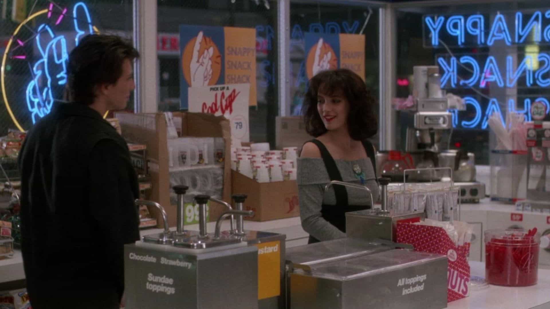 A teenage boy chats with a teenage girl in a convenience store in this image from New World Pictures.