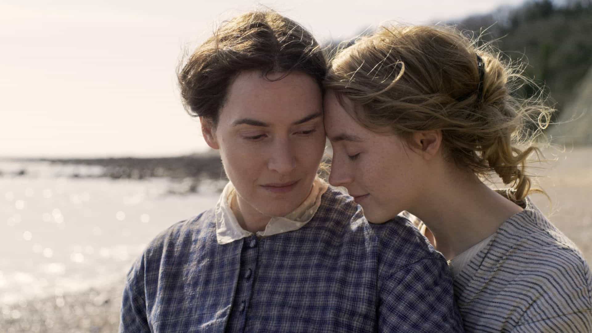 A woman rests her chin on another woman’s shoulder while on the beach in this image from BBC Film.
