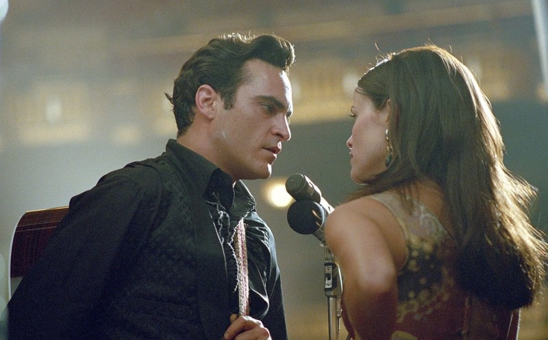 A man and woman sing together at a microphone in this image from Fox 2000 Pictures.