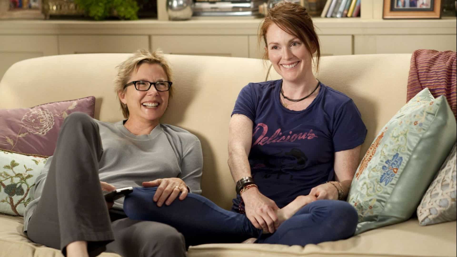 Two women smiling on a couch in this image from Focus Features.