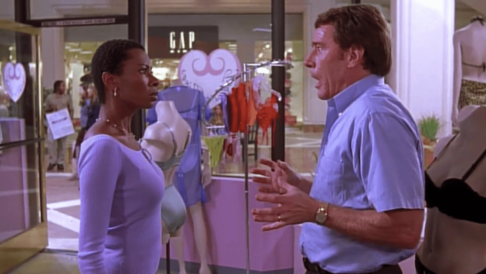 A frantic man speaks to a mall shop employee in this image from Satin City Productions.