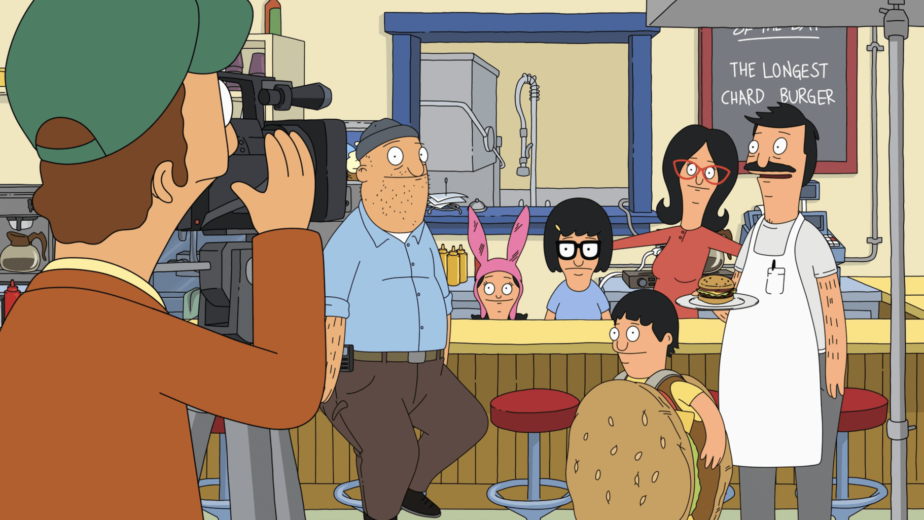 An animated man shoots a TV commercial inside a restaurant in this image from Wilo Productions.