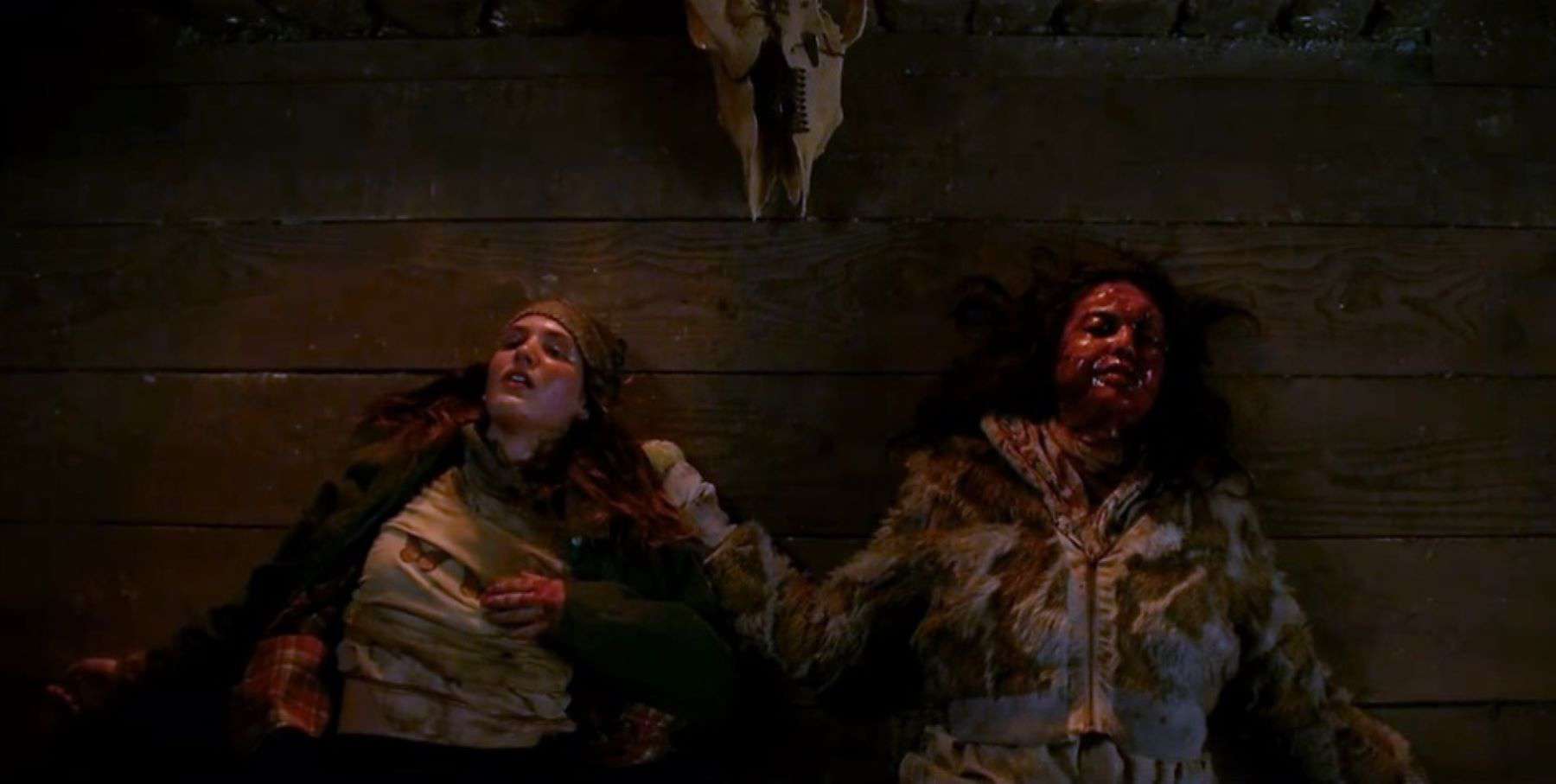 Two girls lay side by side, one covered in blood, in this photo by Showtime. 