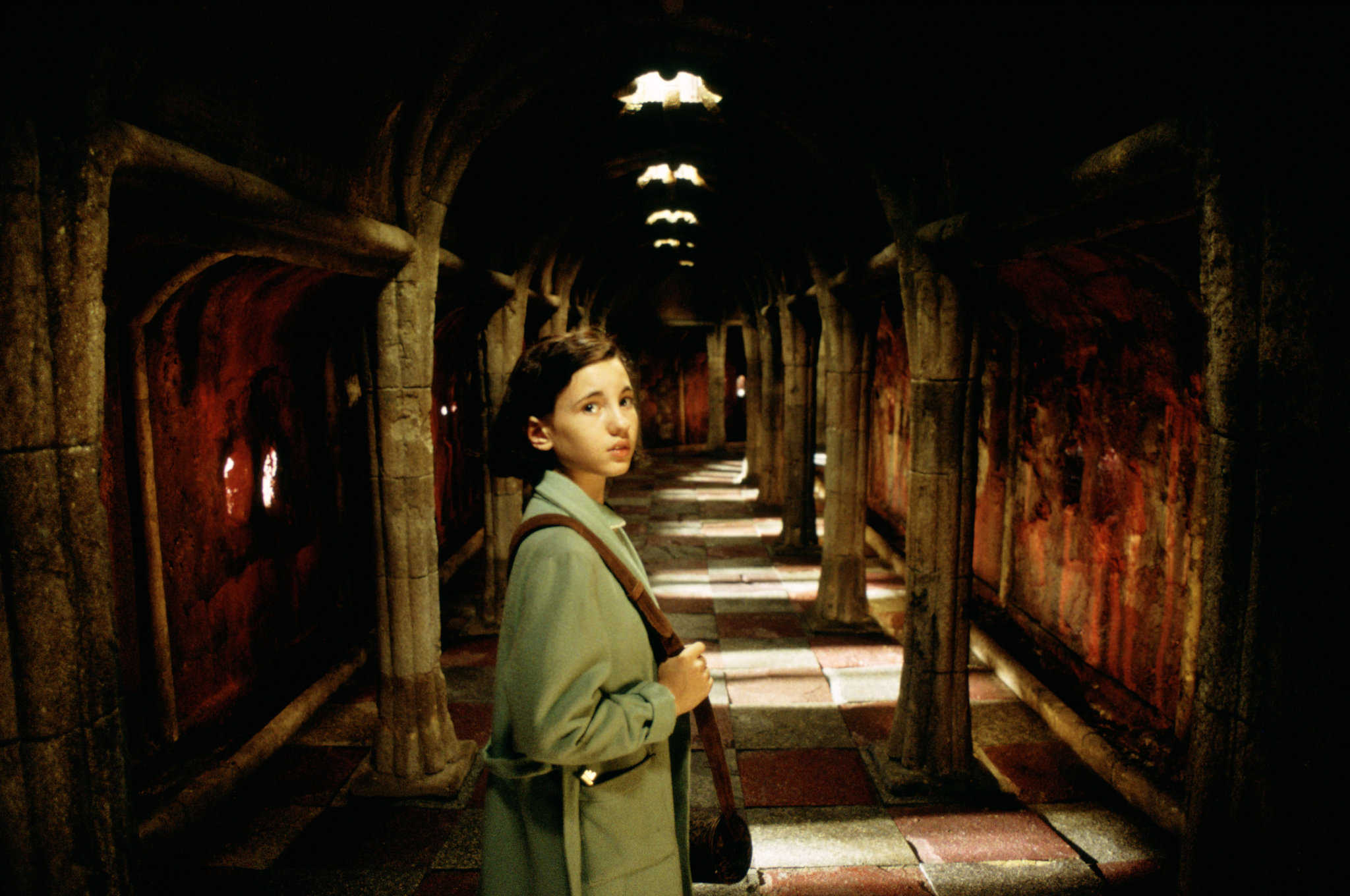 A girl looks over her shoulder in a magical hallway in this image from Estudios Picasso.
