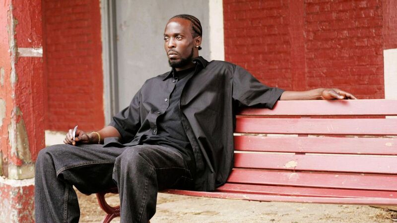 A man wearing all black sits on a bench in this image from Blown Deadline Productions.